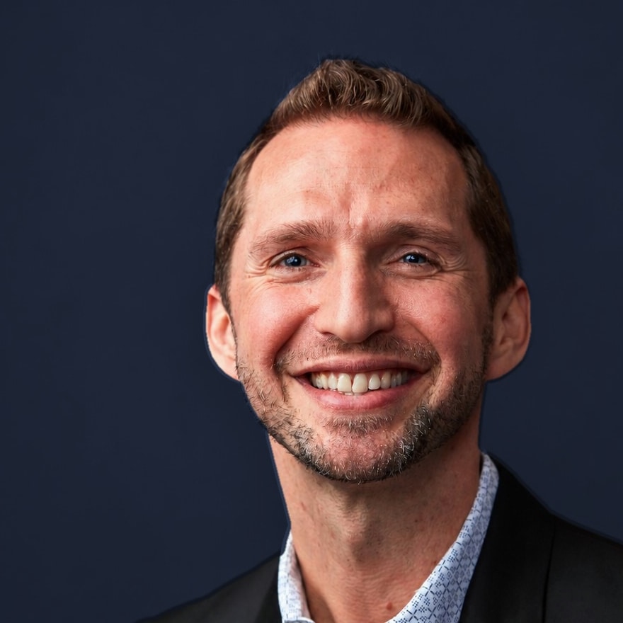 Noel Rosencranz, executive and leadership coach, in a dark jacket against a navy studio background
